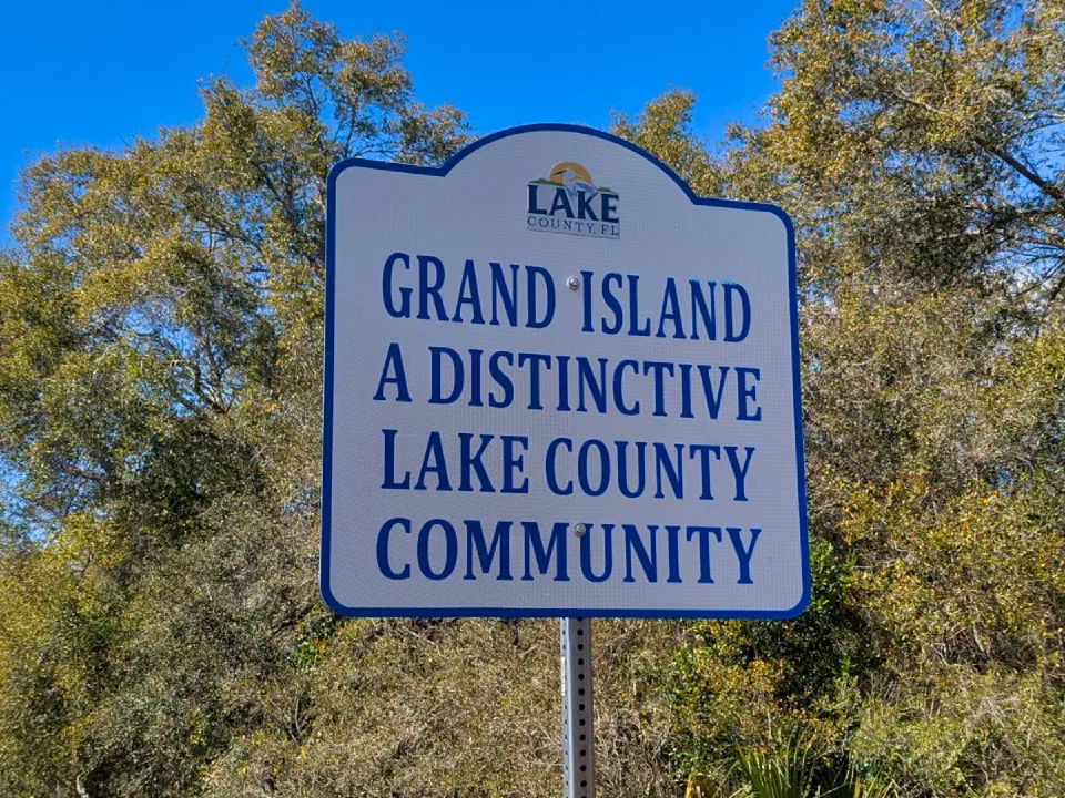\"Grand Island, a Distinctive Lake County community\" road sign in Grand Island, Florida.