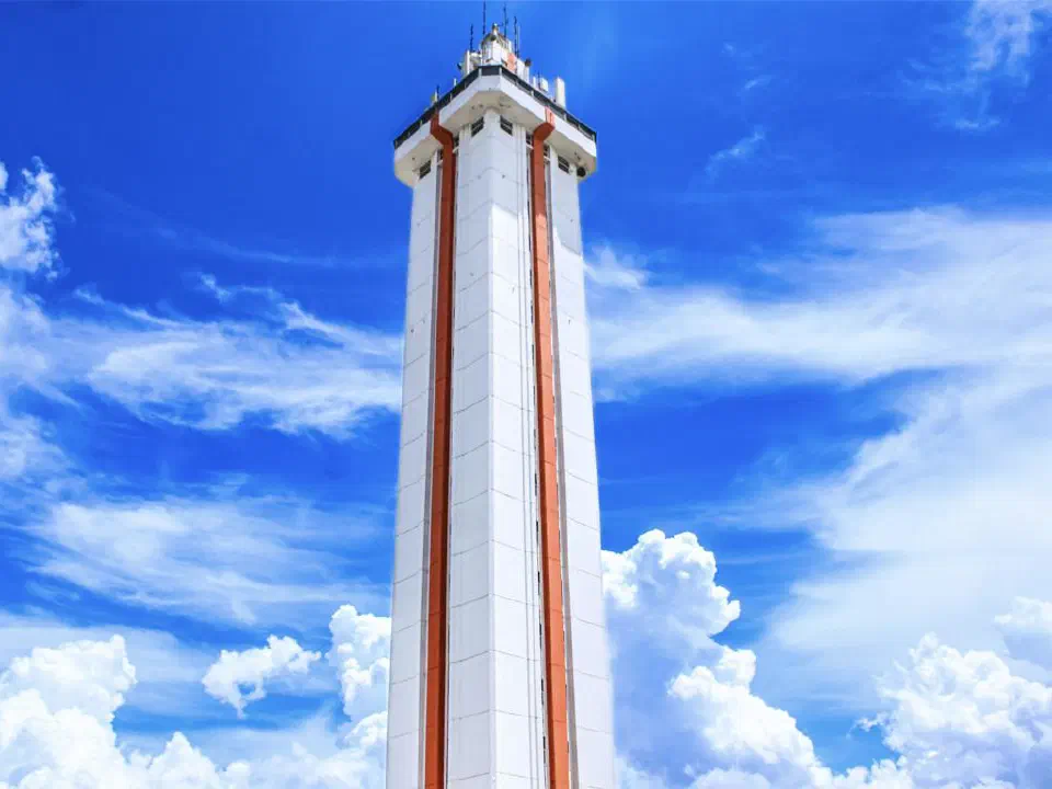 Lake County Citrus Tower against a vibrant blue sky with scattered clouds.