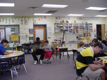Overview shot of Alee Students reading to elementary students