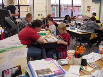 Classroom view of Alee Students reading to elementary students